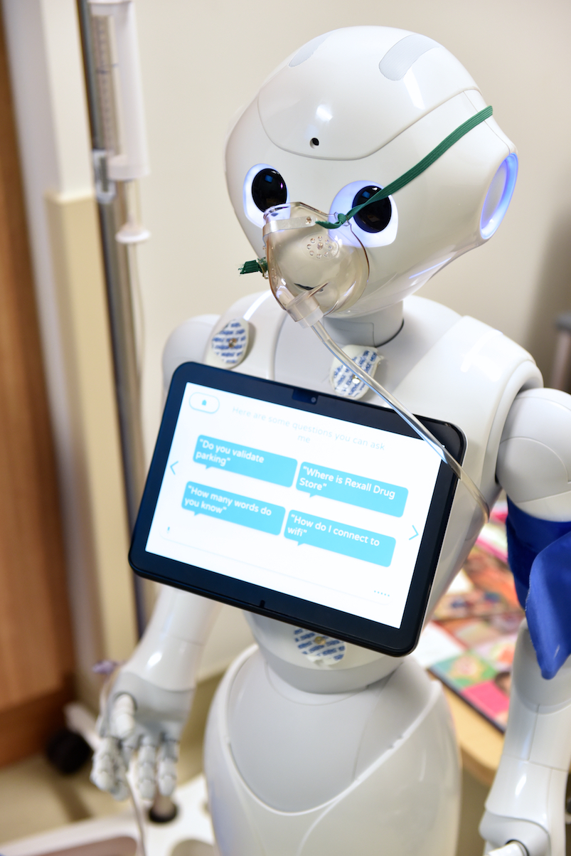 Pepper the robot wears an anaesthesia mask