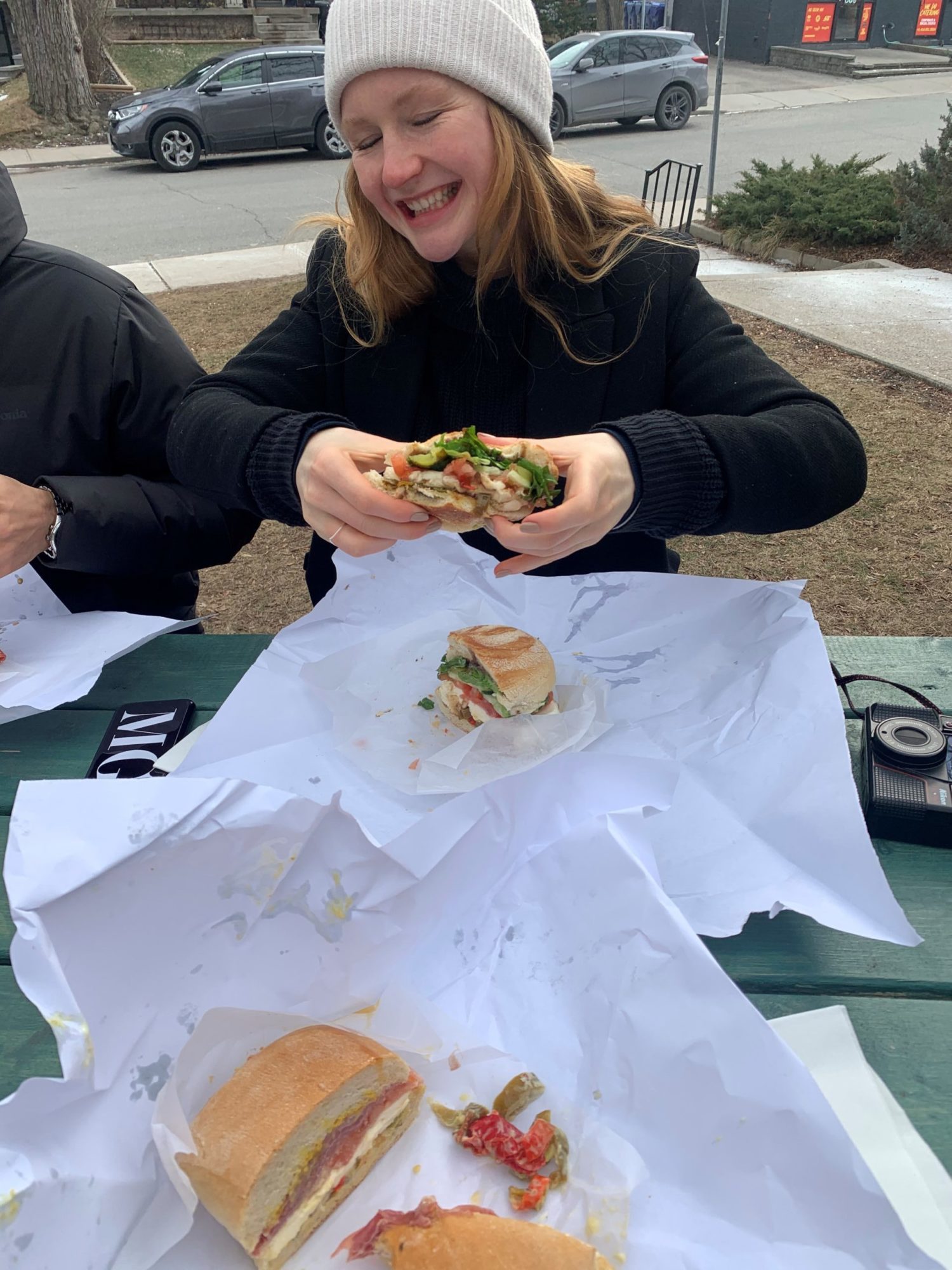 Madeleine eating a sandwich