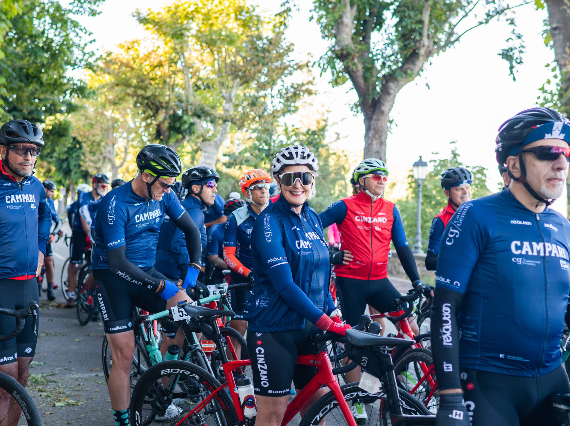 Cecilia is in a crowd of Team Revolution riders on their bikes, smiling at the camera