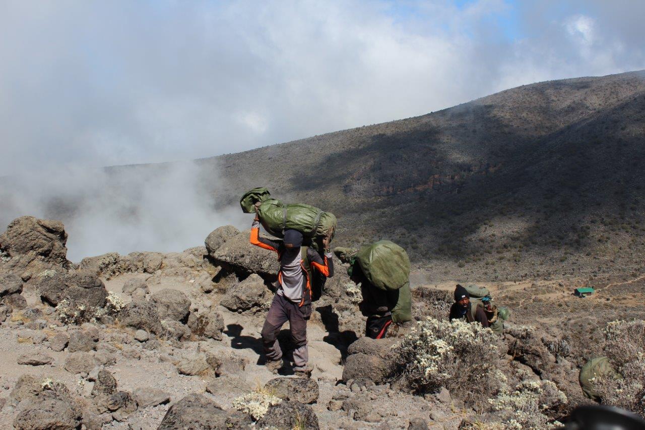 An action photo of Martin and his sons climbing Mount Kilimanjaro